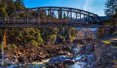 Railroad and State Highway truss bridges cross over the Feather River Gorge photo