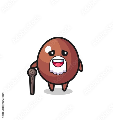 cute chocolate egg grandpa is holding a stick