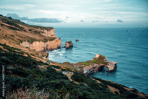 Coastal views with rock formations in the blue ocean photo