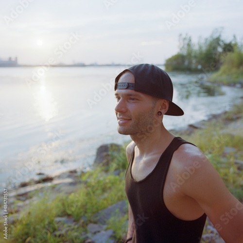 Young man dressed for summer at waterfront