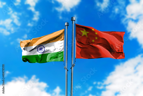 Flags of India and China on the wind against blue sky photo