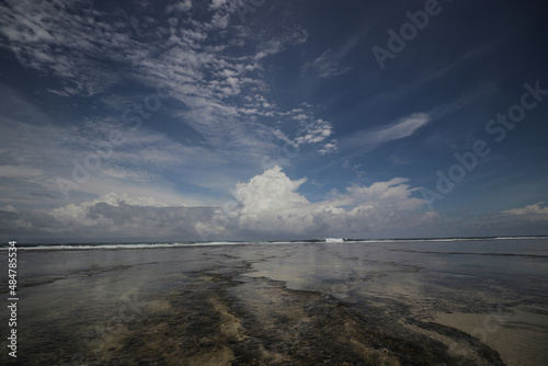 Beautiful tropical beach with blue sky and majestic clouds at Cibuaya Beach Ujung Genteng Sukabumi, West Java, Indonesia.