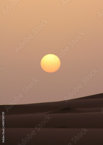 A Perfect Round Sun Setting on the Sahara Desert, Morocco