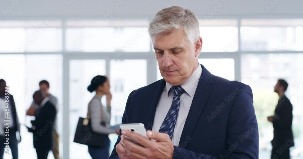 Making space for new business contacts on his phone. Mature caucasian businessman using his smartphone while standing in a busy building. Businessman thinking after reading message, sending a text Making space for new business contacts on his phone. Mature caucasian businessman using his smartphone while standing in a busy building. Businessman thinking after reading message, sending a text