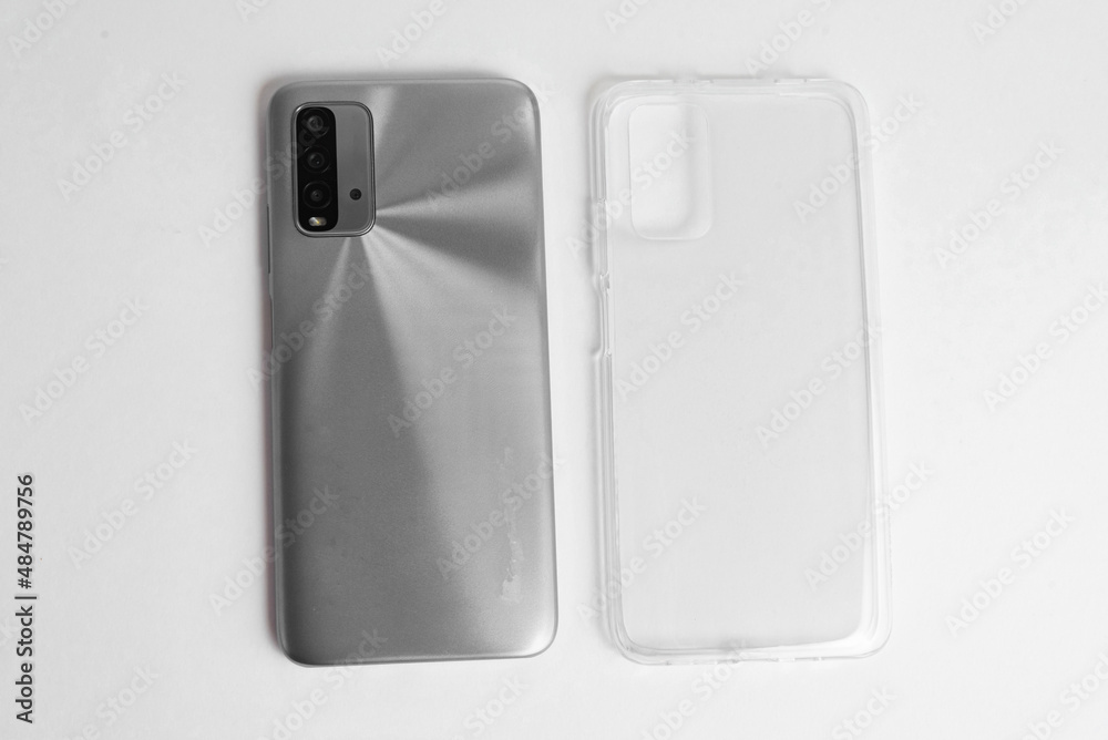 New cellphone with transparent cover over isolated white background New cellphone with transparent cover over isolated white background
