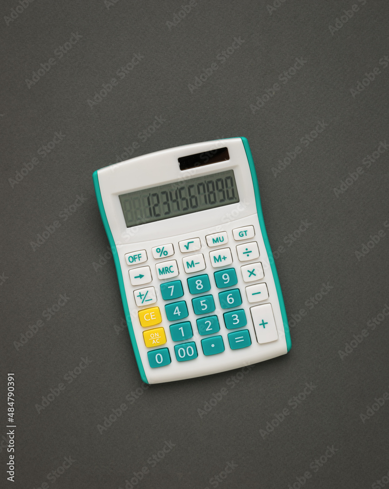 White and green calculator on a dark gray background. White and green calculator on a dark gray background.