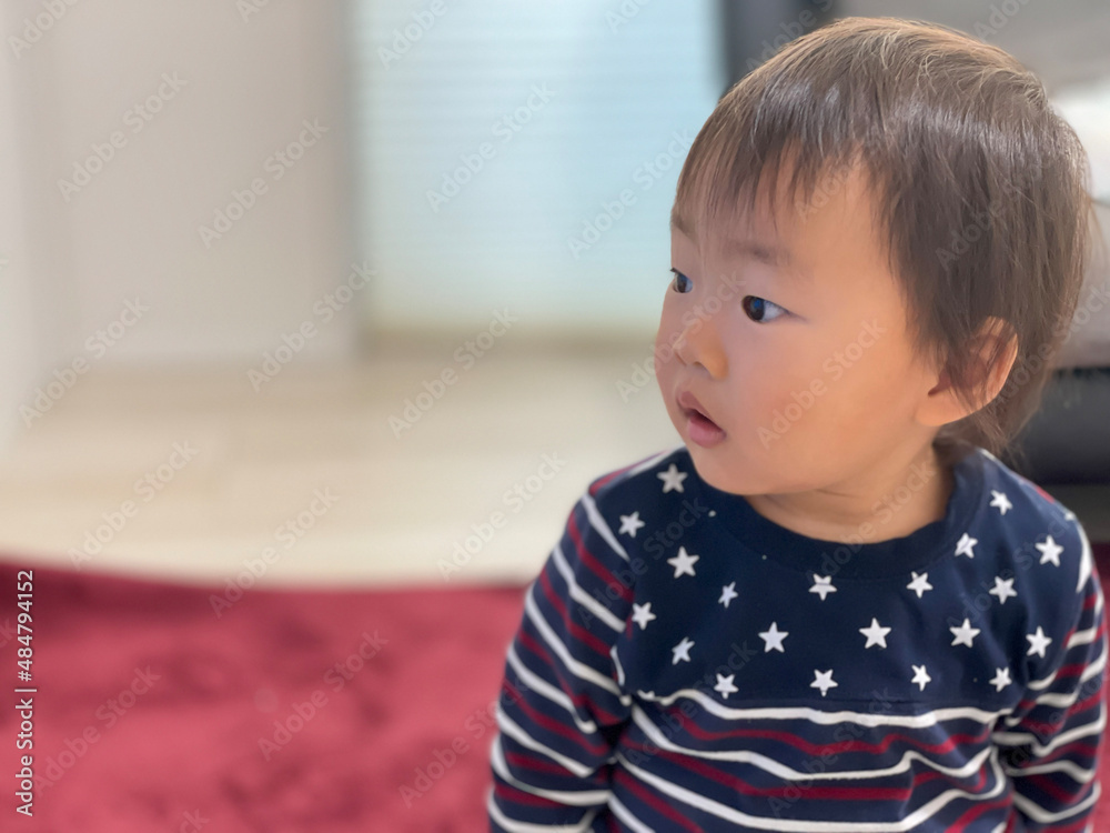 A one-year-old boy with a serious expression A one-year-old boy with a serious expression