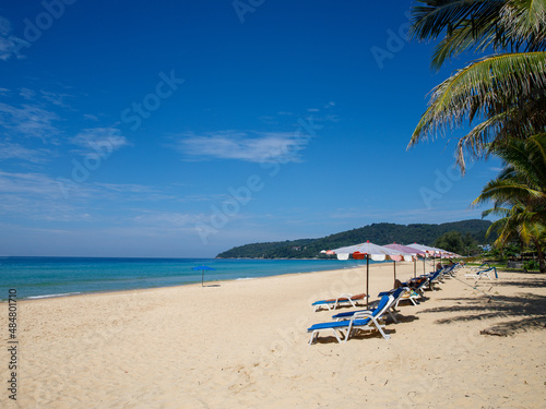 Fototapeta Naklejka Na Ścianę i Meble -  Karon Beach at Phuket , Thailand. White singing sand beach and crystal clear water with line of sun umbrellas. Summer, Nature, Travel, Vacation and Holiday concept.