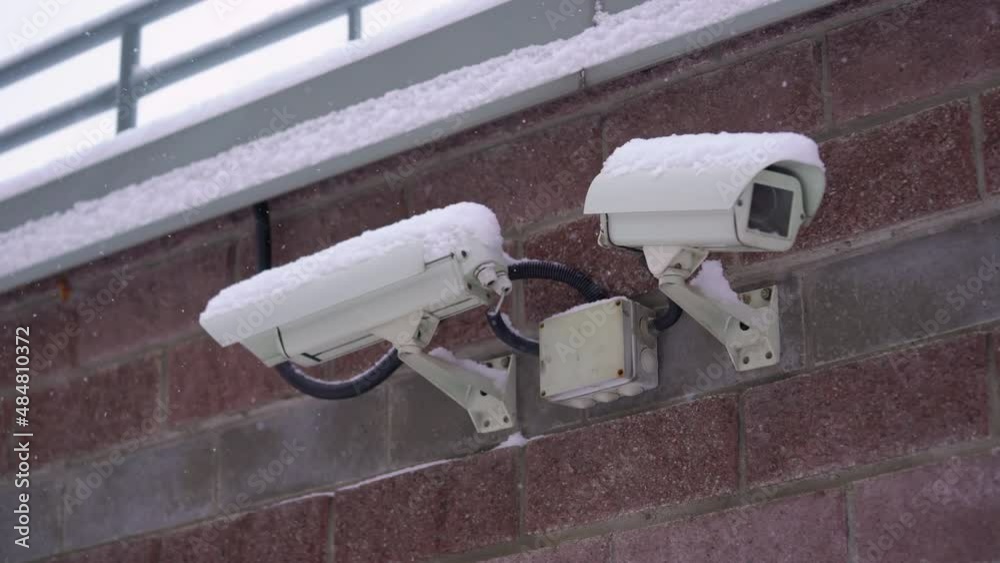 Surveillance and security CCTV camera on a city building wall, security system. Surveillance and security CCTV camera on a city building wall, security system.