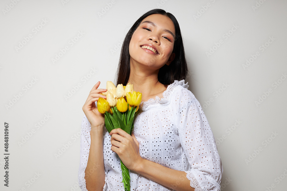 Charming young Asian woman with a bouquet of flowers smile close-up Lifestyle unaltered Charming young Asian woman with a bouquet of flowers smile close-up Lifestyle unaltered