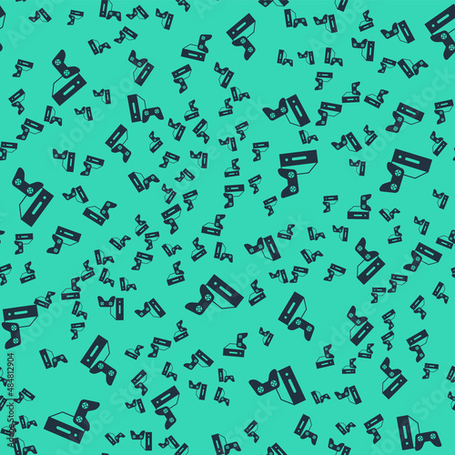 Black Video game console with joystick icon isolated seamless pattern on green background. Vector