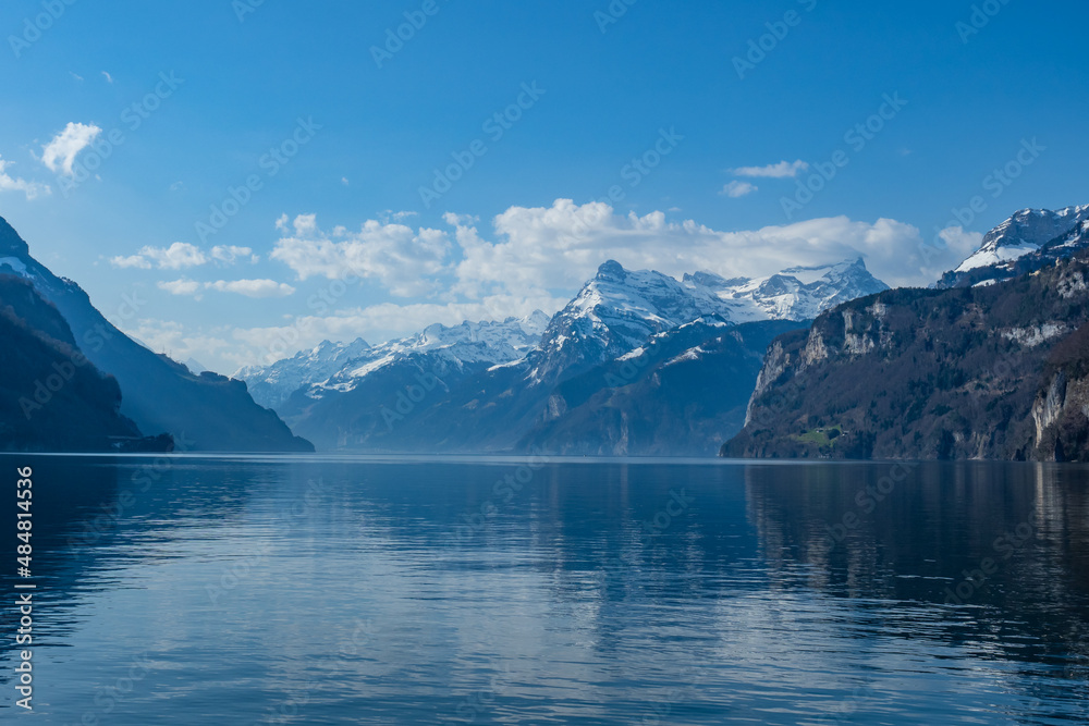 View over lake Vierwaldstaettersee, Switzerland, towards the snow covered mountains on a sunny spring day