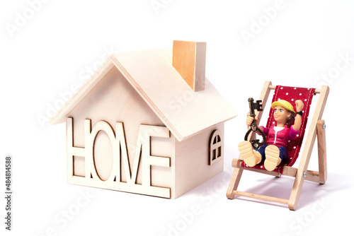 A figurine of a symbolic person and a wooden symbolic house on a white background photo