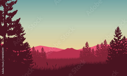 Fantastic view of the mountains from the edge of the forest with the silhouettes of the surrounding trees