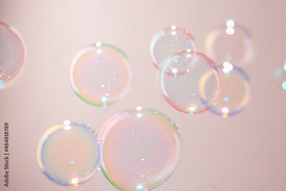 Beautiful Colorful Transparent Soap Bubbles Floating on Pink Background
