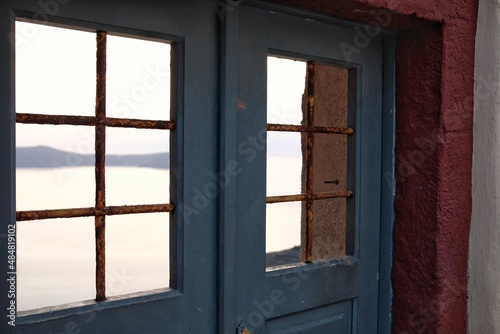 A window frame overlooking the aegean sea in Santorini Greece