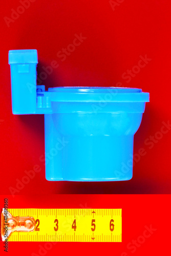 Toilet bowl on a  background.  tape-measures on the background. Measurement of the size.