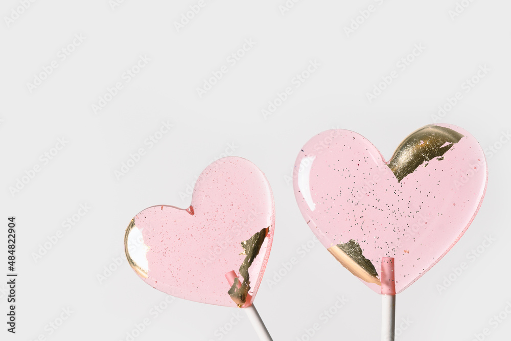 Lollipops pink candy on stick isolated on white background. Sweets couple. Happy Valentine's day romantic greeting card. Copy space.