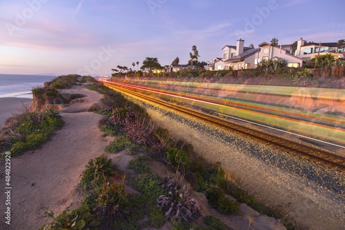 Transparent Silhouette of High Speed Coaster Train on Railway Tracks along Southern California Pacific Ocean Coastline in Del Mar, San Diego County photo