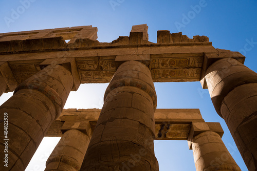 Egyptian antique columns on a blue sky.