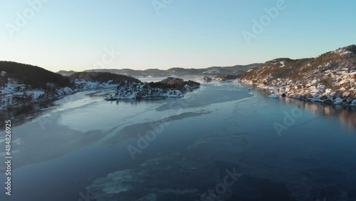 Calm Freezing Water Of Strait Near Kragerø On A Sunny Winter Day In Norway. - aerial photo