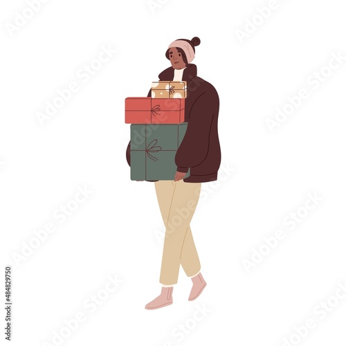 Woman walking, holding gift boxes stack in hands. Female going, carrying Chri...