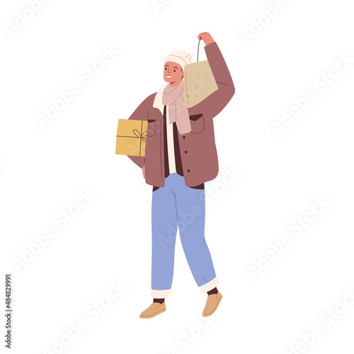 Man going with holiday gift and shopping bag. Happy person walking and holdin...