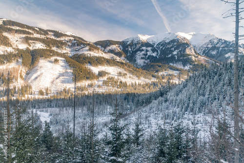 Fototapeta Naklejka Na Ścianę i Meble -  View of the white snow-capped peaks at Tatra mountains at winter time. Winter landscape view on Slovakia mountains from Poland.