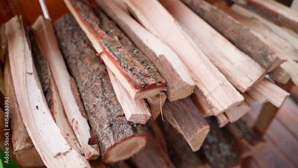 Firewood for lighting a fire for a fireplace and barbecue lies neatly