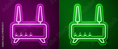 Glowing neon line Router and wi-fi signal icon isolated on purple and green background. Wireless ethernet modem router. Computer technology internet. Vector