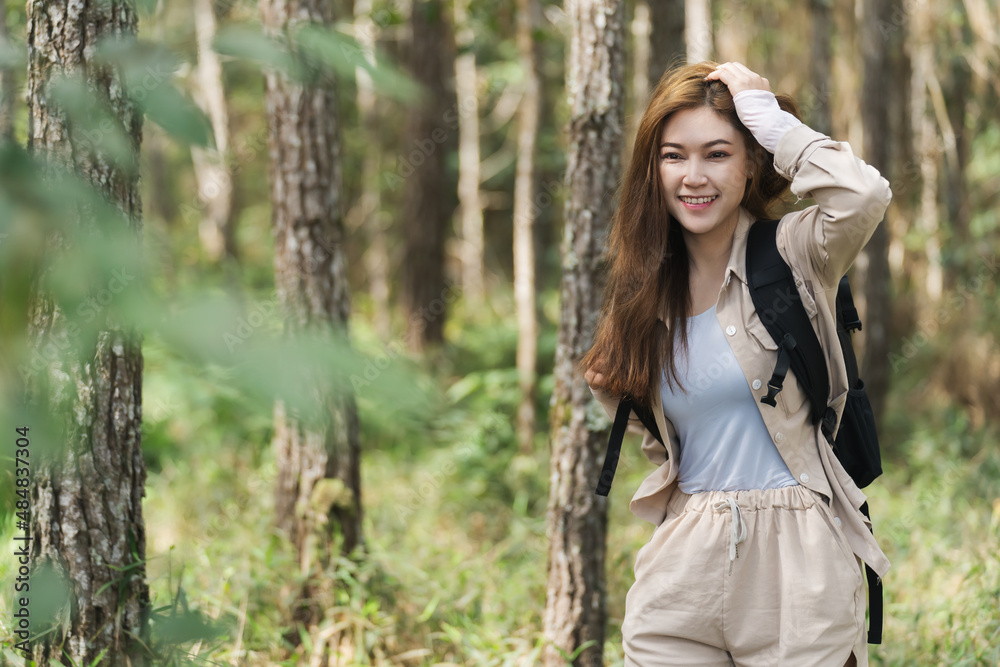 happy woman carrying a backpack travel in the forest happy woman carrying a backpack travel in the forest