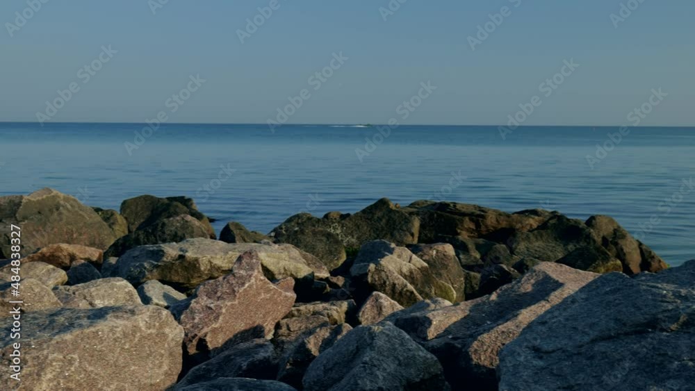 View through the large stones to the sea. Seascape in the morning. slow motion View through the large stones to the sea. Seascape in the morning. slow motion