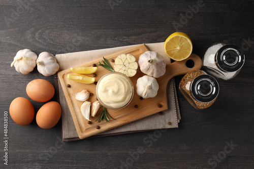Concept of cooking garlic sauce on wooden background