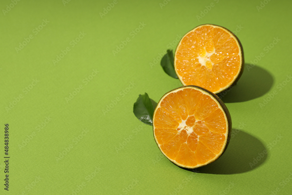 Halves of chocolate orange on green background Halves of chocolate orange on green background