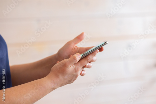 Woman holding  using smart phone and reading phone message. Hands holding mobile phone and typing