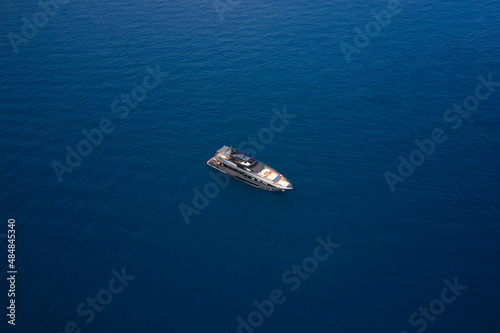 Big gray super boat on the water aerial view. Big yacht for millionaires in the sea drone view. Luxurious gray blue Mega yacht on dark water top view. © Berg