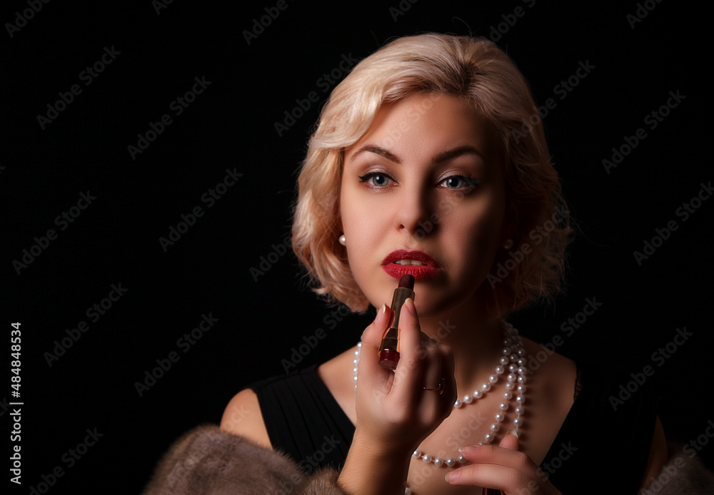 young woman paints her lips with lipstick young woman paints her lips with lipstick