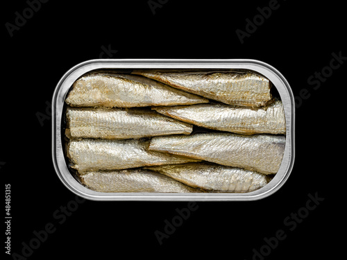 Top view of a tin can with sardines inside on a black background so that it can be silhouetted and the background can be changed.