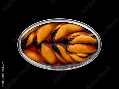 Overhead view of a tin can with mussels inside on a black background so that it can be silhouetted and the background can be changed.