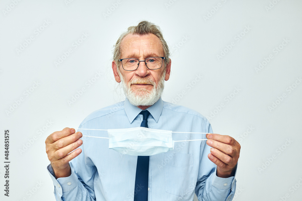 Portrait of happy senior man medical safety mask health light background Portrait of happy senior man medical safety mask health light background