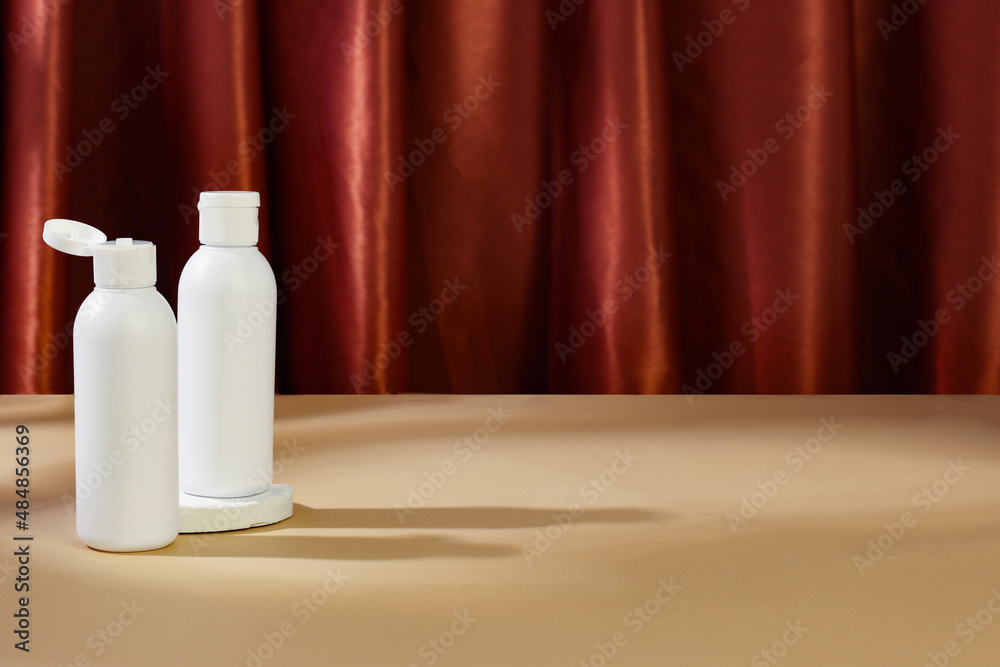 Skincare beauty cosmetic concept. White tube of cream lotion cleanser antioxidant facial oil on brown background, copyspace, banner Skincare beauty cosmetic concept. White tube of cream lotion cleanser antioxidant facial oil on brown background, copyspace, banner