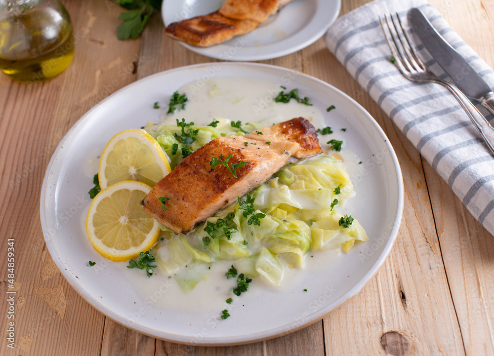 Fish with cabbage and bechamel sauce on a plate Fish with cabbage and bechamel sauce on a plate