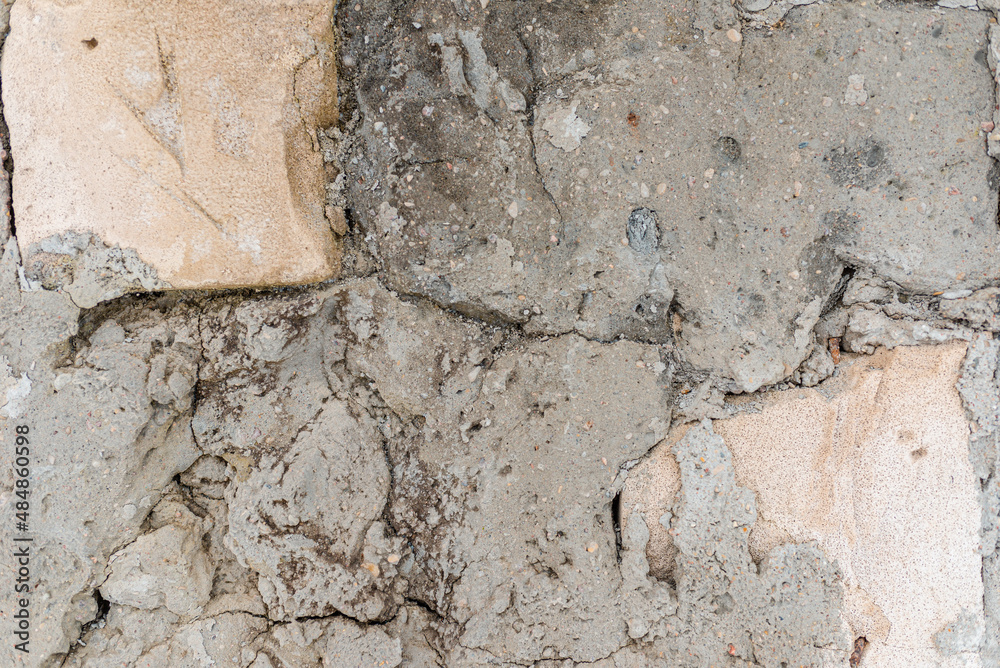 Fototapeta premium Cracked concrete wall gray cement surface background.cracked grey stone wall in winter.close-up.