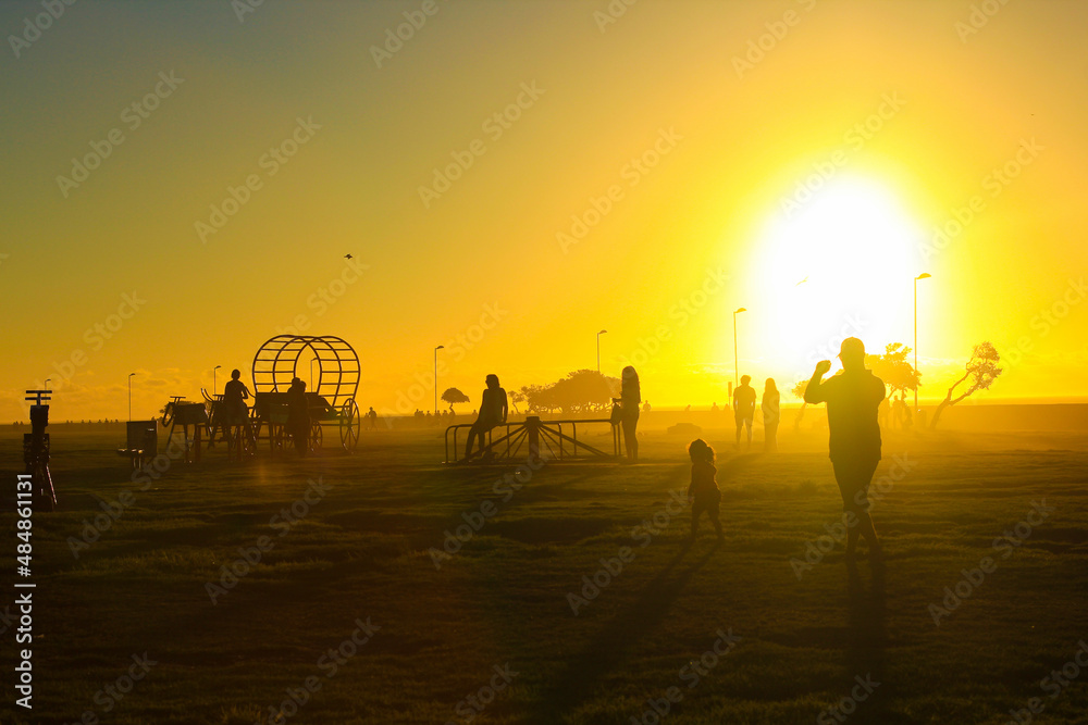 yellow sunset with people silhouettes in Cape Town, South Africa. High-quality photo