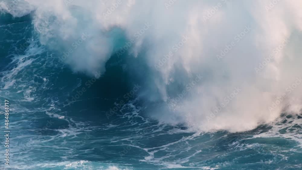 Slow motion shot of powerful wave crashing. Sea or ocean big stormy surf clear turquoise water with foamy white texture Slow motion shot of powerful wave crashing. Sea or ocean big stormy surf clear turquoise water with foamy white texture