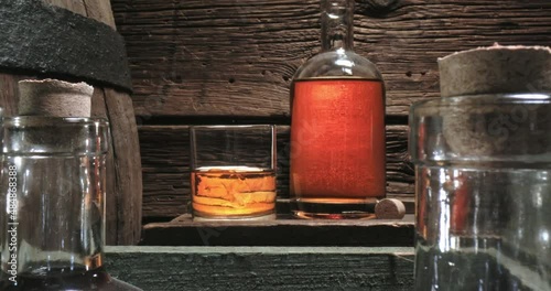 Hand crafted whisky in old distillery warehouse. Glass of cognac.