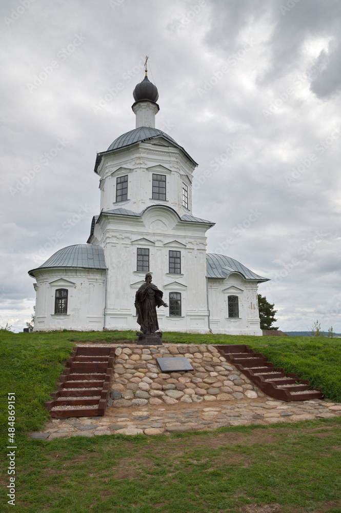 Tver Region, Russia - August 30, 2021: The monastery of the Nilo-Stolobenskaya deserts. Monument to Hieromonk Ambrose Matveev near the Church of the Exaltation of the Cross of the Lord Tver Region, Russia - August 30, 2021: The monastery of the Nilo-Stolobenskaya deserts. Monument to Hieromonk Ambrose Matveev near the Church of the Exaltation of the Cross of the Lord