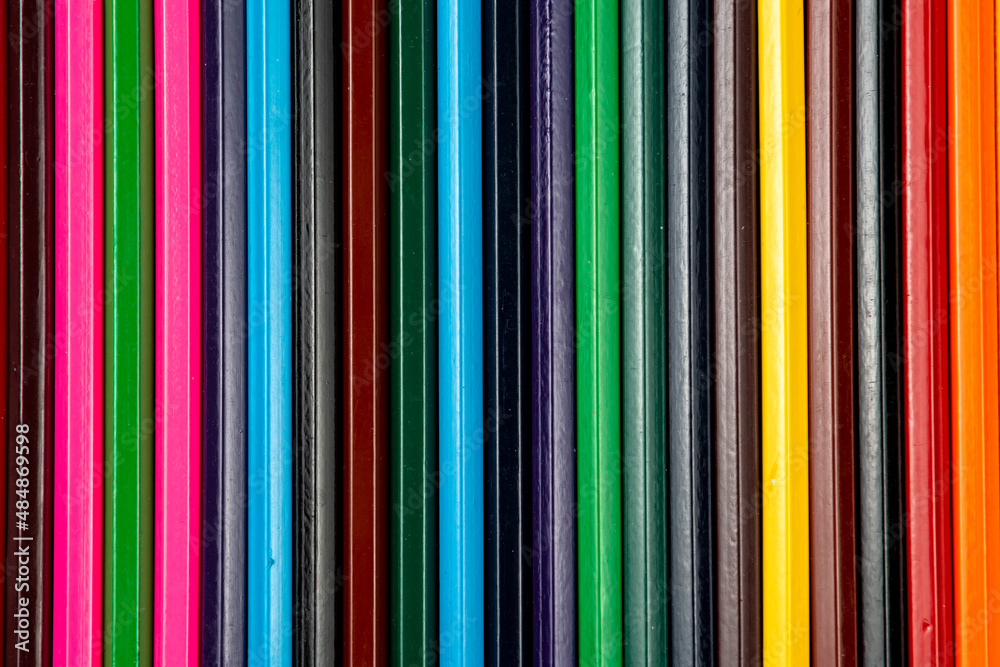 Colored pencils in the form of an abstract background. close-up.