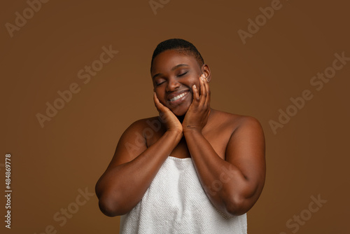 Beautiful plus size African american woman posing at studio