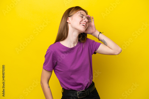 Young English woman isolated on yellow background smiling a lot
